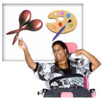 Woman in a wheelchair pointing to a poser with a paint pallet and maracas on it